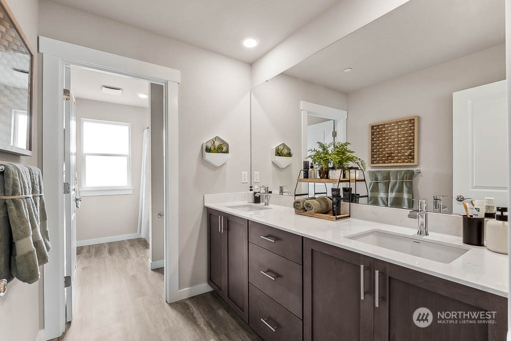 16213 Southeast 133rd Place, Unit 113 Renton, WA 98059 - Photo 21 of 30 a bathroom with a double vanity sink a mirror and a shower