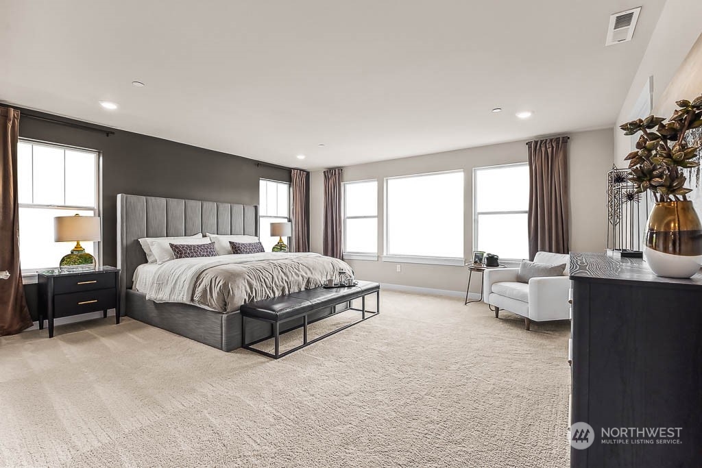 16213 Southeast 133rd Place, Unit 113 Renton, WA 98059 - Photo 25 of 30 a spacious bedroom with a bed and a couch