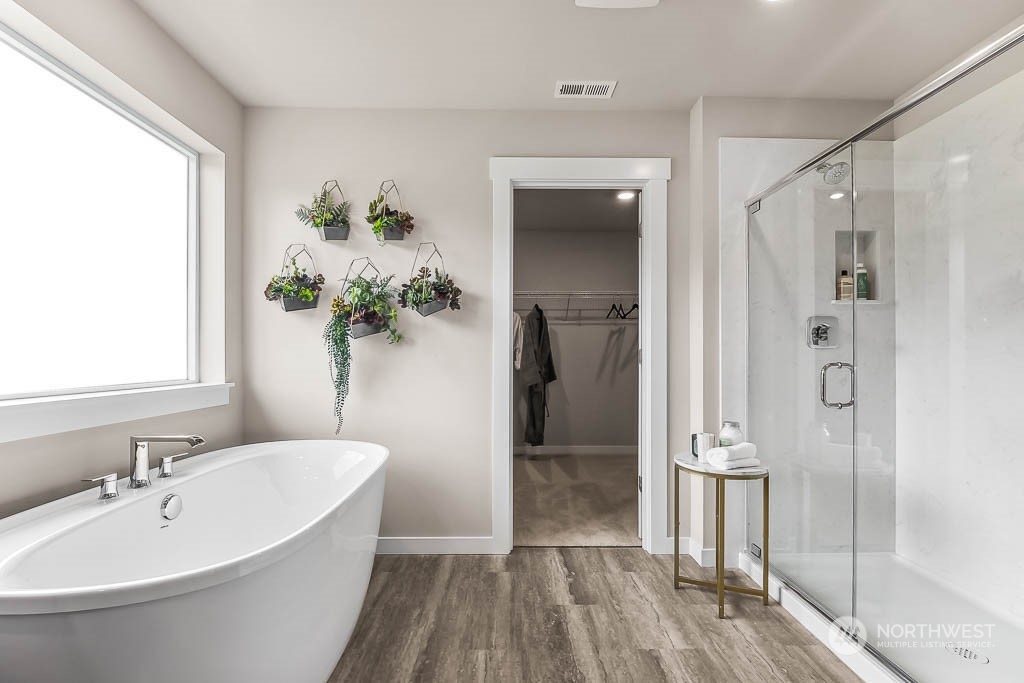 16213 Southeast 133rd Place, Unit 113 Renton, WA 98059 - Photo 27 of 30 a bathroom with a bathtub and a shower
