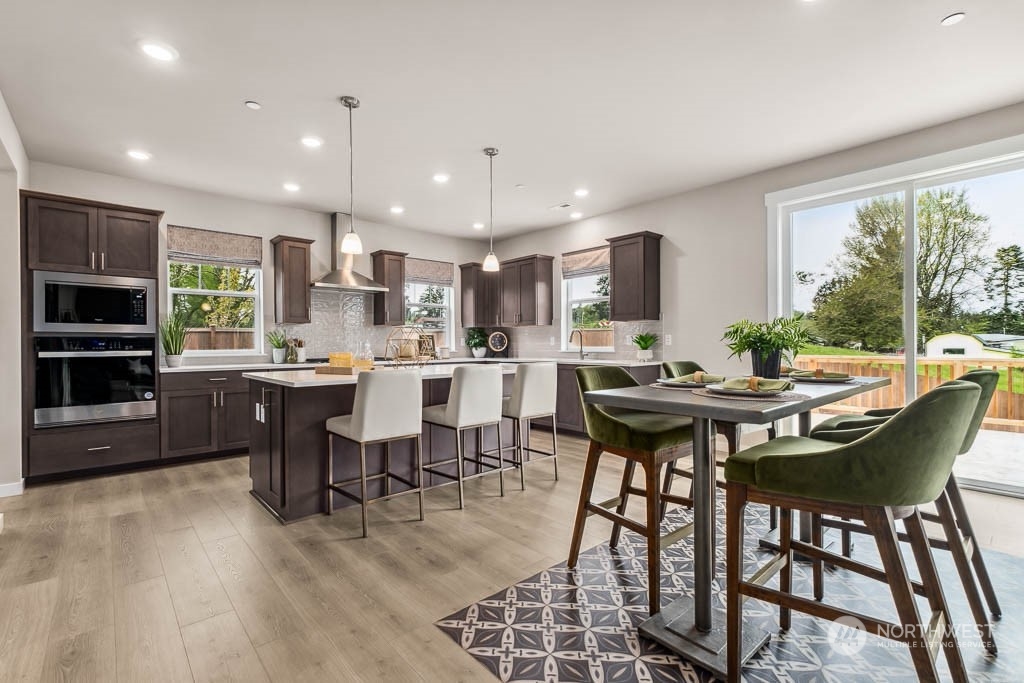 16213 Southeast 133rd Place, Unit 113 Renton, WA 98059 - Photo 10 of 30 a kitchen with a table and chairs in it