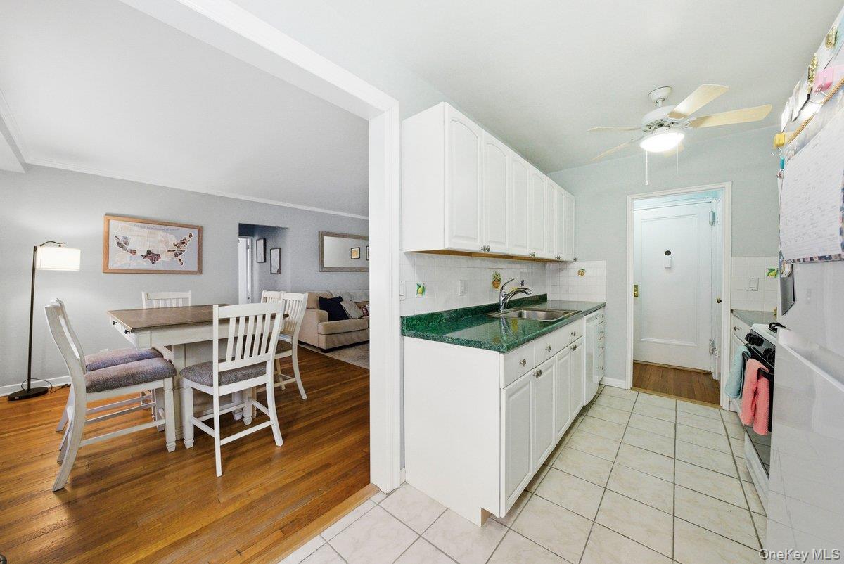 781 Palmer Road, Unit 2D Yonkers, NY 10708 - Photo 5 of 17 a kitchen with a cabinets and chairs
