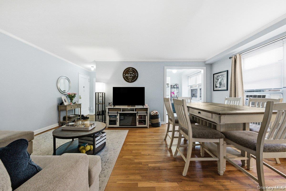 781 Palmer Road, Unit 2D Yonkers, NY 10708 - Photo 9 of 17 a living room with furniture a flat screen tv and kitchen view