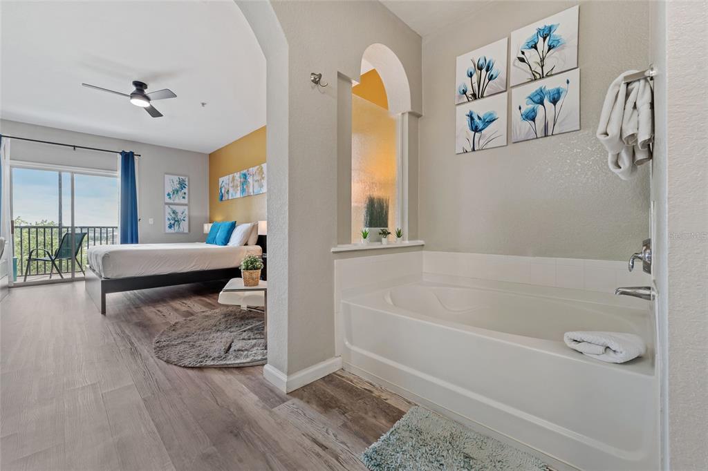 14200 Avalon Road, Unit 409 Winter Garden, FL 34787 - Photo 20 of 33 a bathroom with a tub and a shower