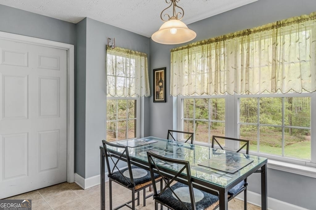 80 Upper Caldwell Road Bowdon, GA 30108 - Photo 10 of 33 a view of a dining room with furniture window and outside view