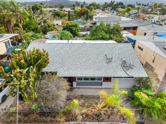 an aerial view of a house with a yard