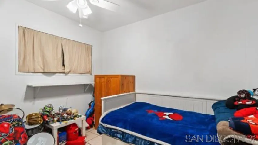 753 Jacumba Street San Diego, CA 92114 - Photo 11 of 22 a room with lots of white furniture and a chandelier