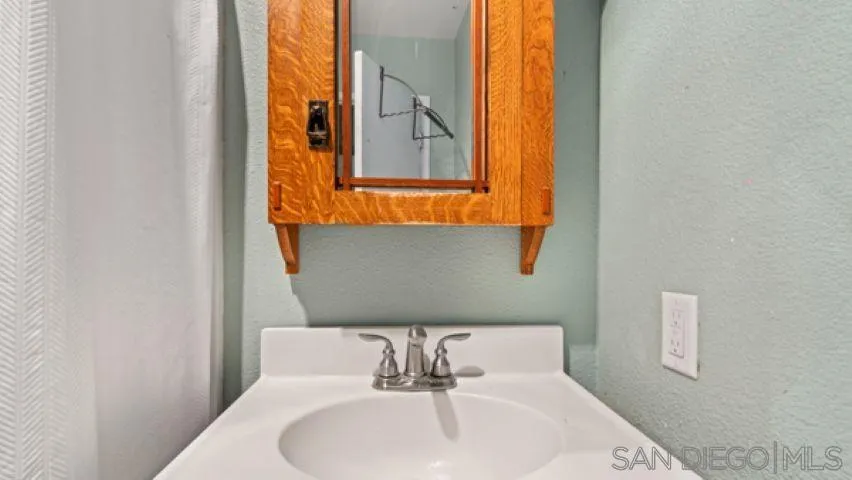 753 Jacumba Street San Diego, CA 92114 - Photo 14 of 22 a bathroom with a sink and a mirror