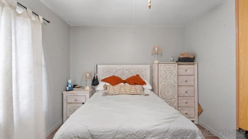 753 Jacumba Street San Diego, CA 92114 - Photo 19 of 22 a bedroom with a bed and a night stand