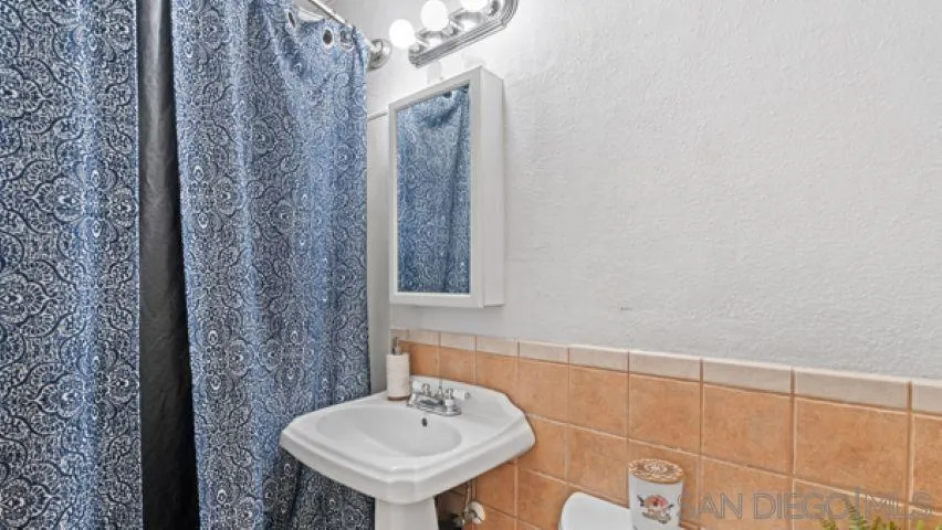 753 Jacumba Street San Diego, CA 92114 - Photo 20 of 22 a bathroom with a sink and a mirror