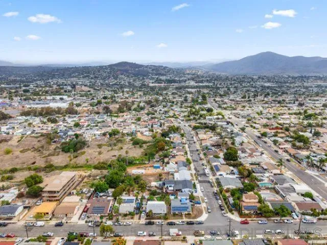 an aerial view of residential houses with city view