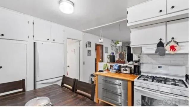 a kitchen with stainless steel appliances granite countertop a stove and a refrigerator