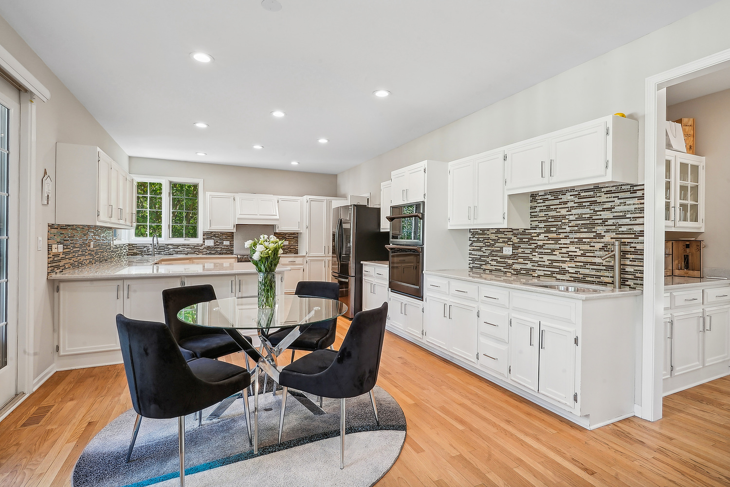 9033 Kearney Road Darien, IL 60561 - Photo 18 of 38 a kitchen with granite countertop kitchen island stainless steel appliances a stove a dining table and chairs