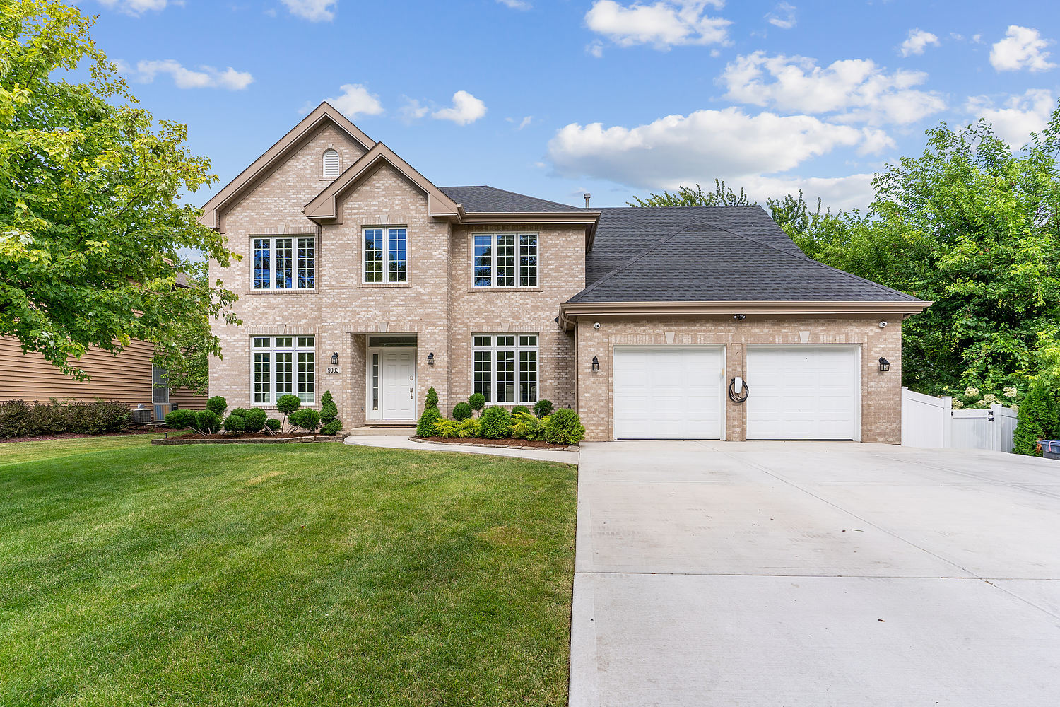 9033 Kearney Road Darien, IL 60561 - Photo 2 of 38 a front view of a house with a yard and garage