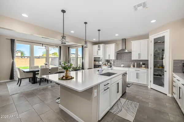 a kitchen with a sink stove and cabinets