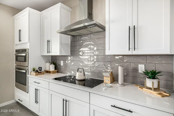 a kitchen with stainless steel appliances white cabinets and a stove
