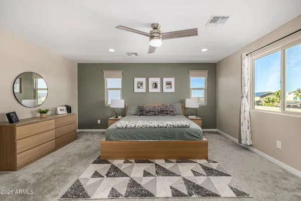 a spacious bedroom with a large bed and a dresser