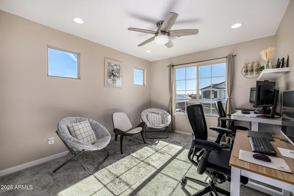 a view of a workspace with furniture and a window