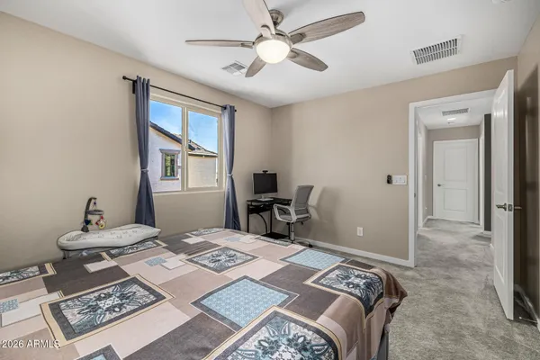 a bedroom that has a bed and a table in it