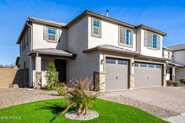a front view of a house with a yard and garage