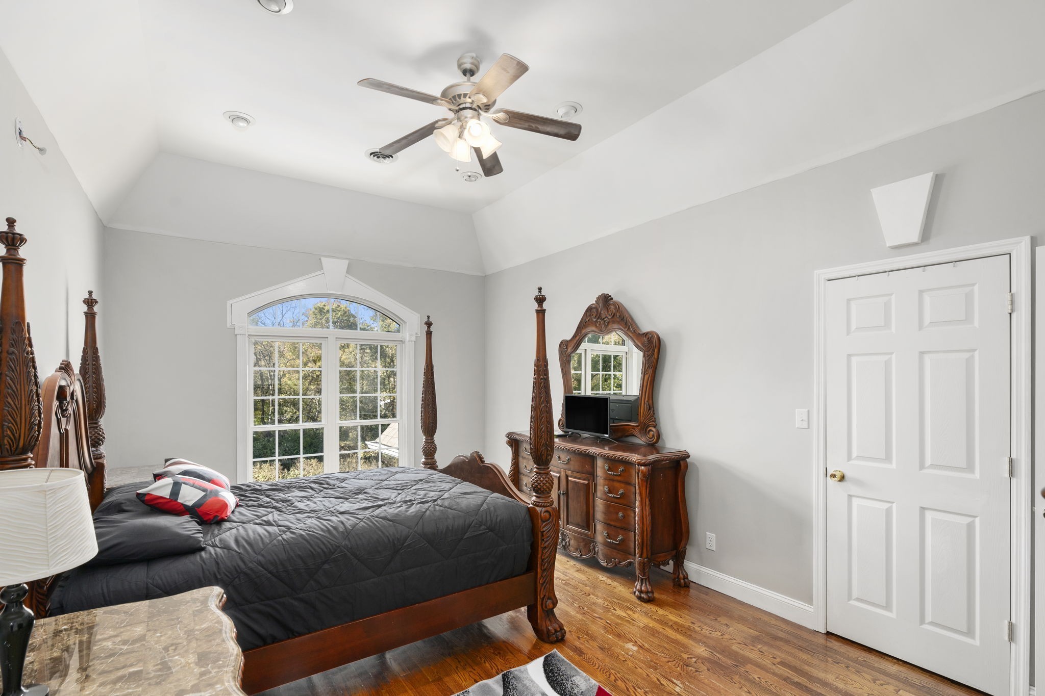265 Dorris Road Portland, TN 37148 - Photo 31 of 37 a bedroom with a bed a window and a chandelier