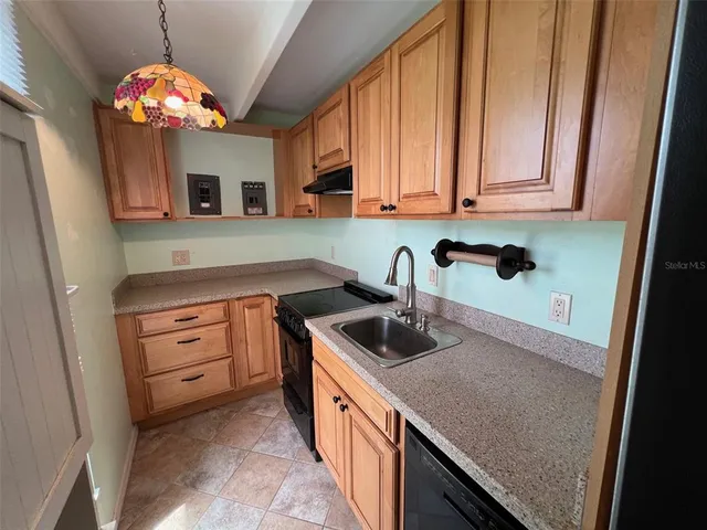 a kitchen with a sink stove and microwave