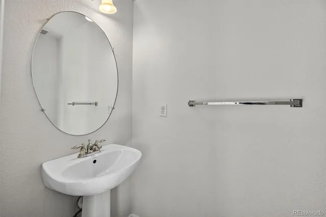 a bathroom with a sink a mirror and a shower