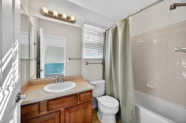 a bathroom with a sink toilet a mirror and shower