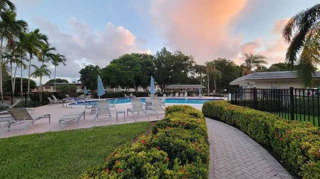 a swimming pool with outdoor seating and yard
