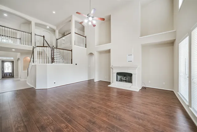 a view of a livingroom with wooden floor and a fireplace