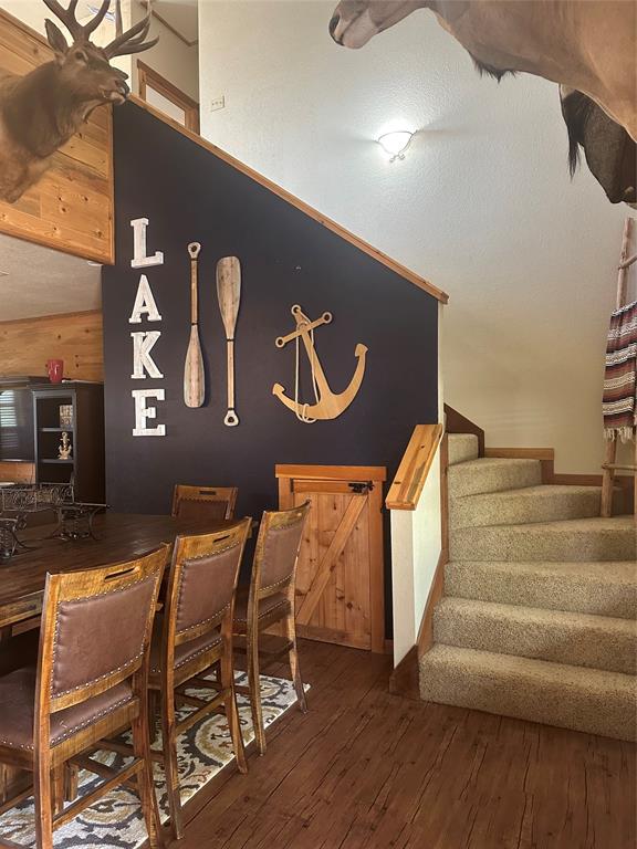 572 Oak Point Drive May, TX 76857 - Photo 21 of 36 Dining space featuring stairs and wood-type flooring