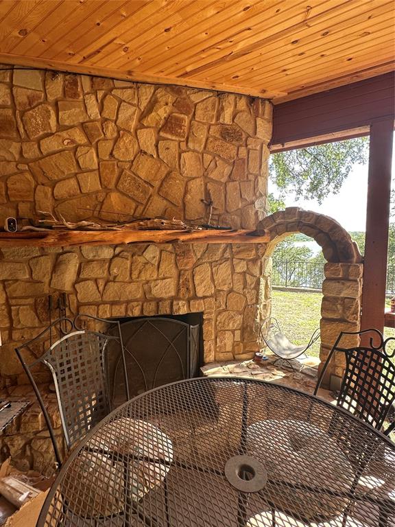 572 Oak Point Drive May, TX 76857 - Photo 3 of 36 Detailed view of an outdoor stone fireplace and stone siding