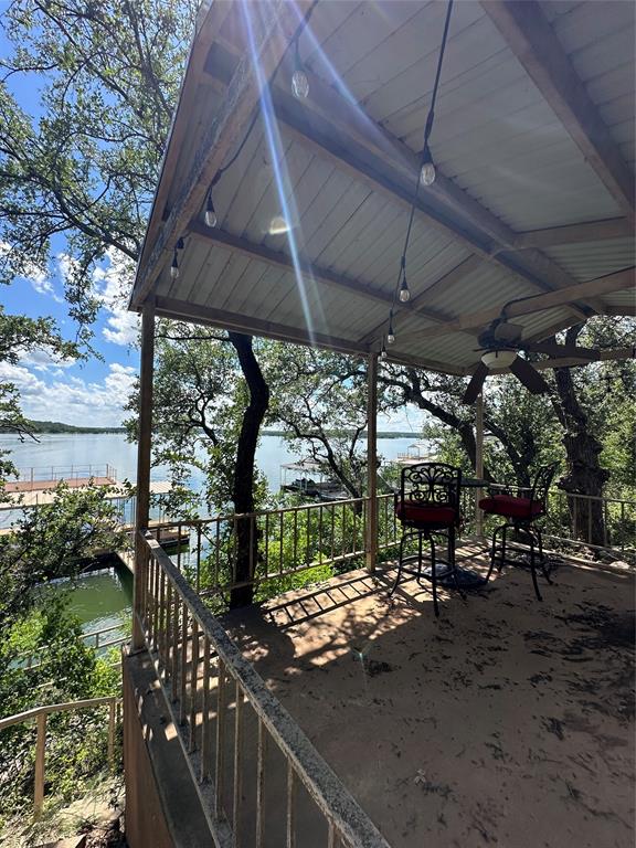 572 Oak Point Drive May, TX 76857 - Photo 35 of 36 View of patio / terrace featuring a water view and a ceiling fan