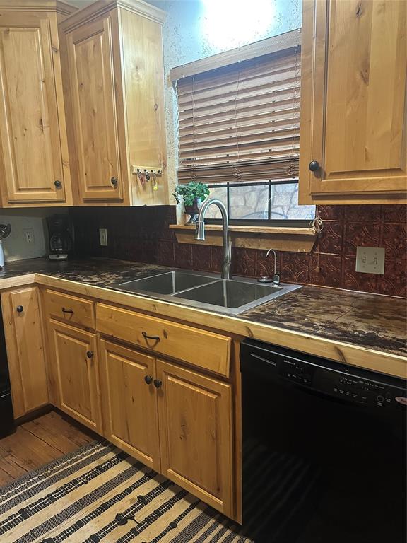572 Oak Point Drive May, TX 76857 - Photo 8 of 36 Kitchen with paneled dishwasher, tasteful backsplash, light brown cabinetry, and wood finished floors