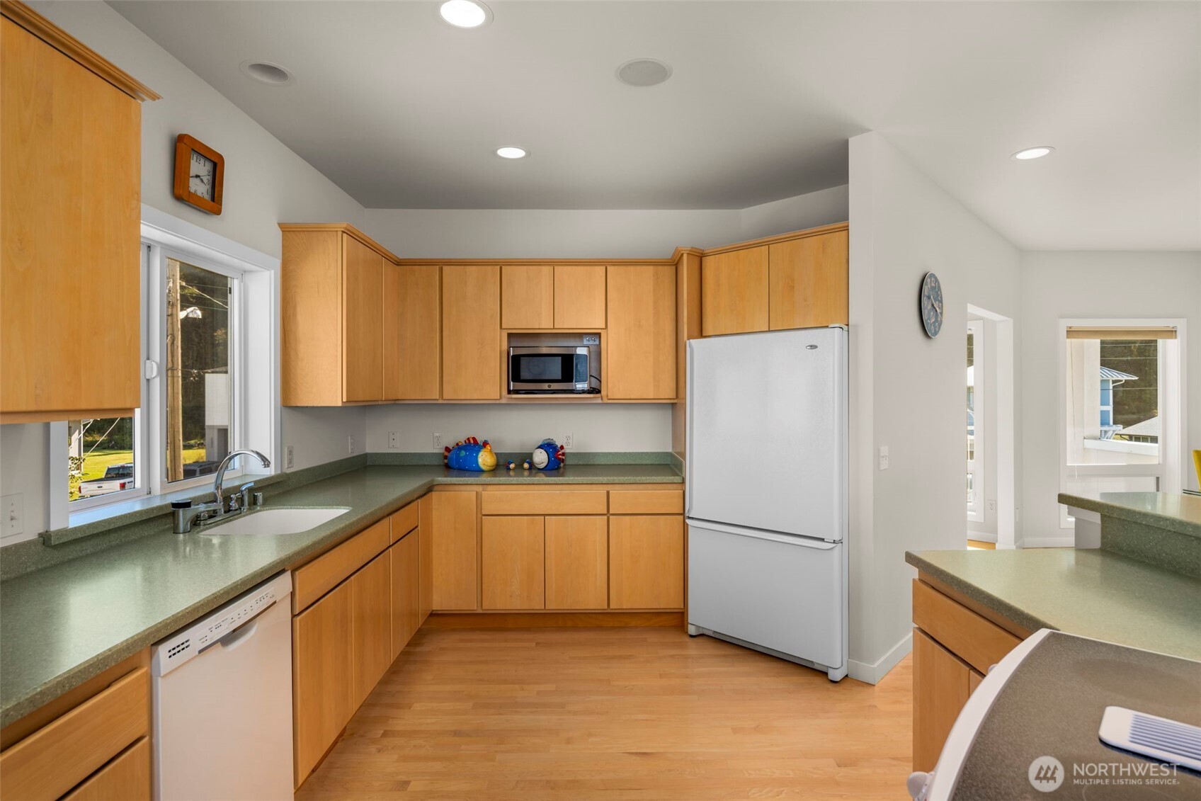 6436 South Ebb Tide Lane Freeland, WA 98249 - Photo 15 of 40 a kitchen with a refrigerator a sink and cabinets
