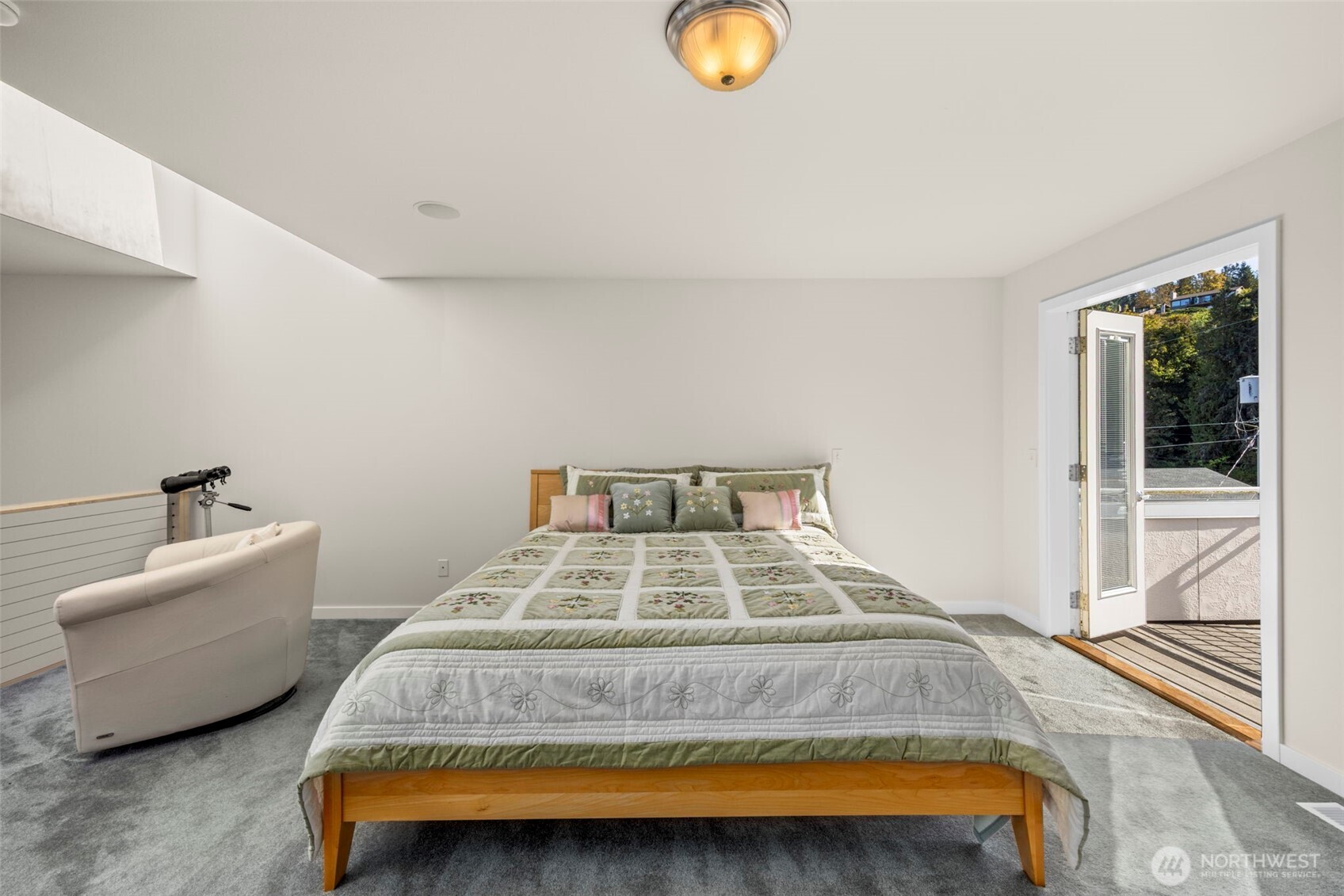 6436 South Ebb Tide Lane Freeland, WA 98249 - Photo 18 of 40 a bedroom with a bed and a large window