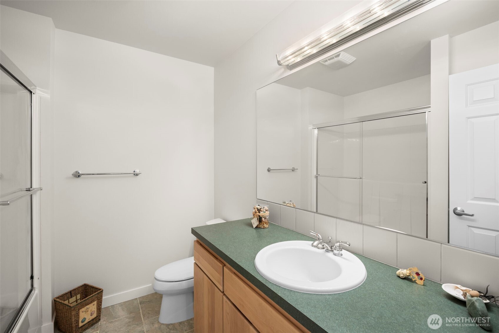 6436 South Ebb Tide Lane Freeland, WA 98249 - Photo 30 of 40 a bathroom with a granite countertop sink and a mirror