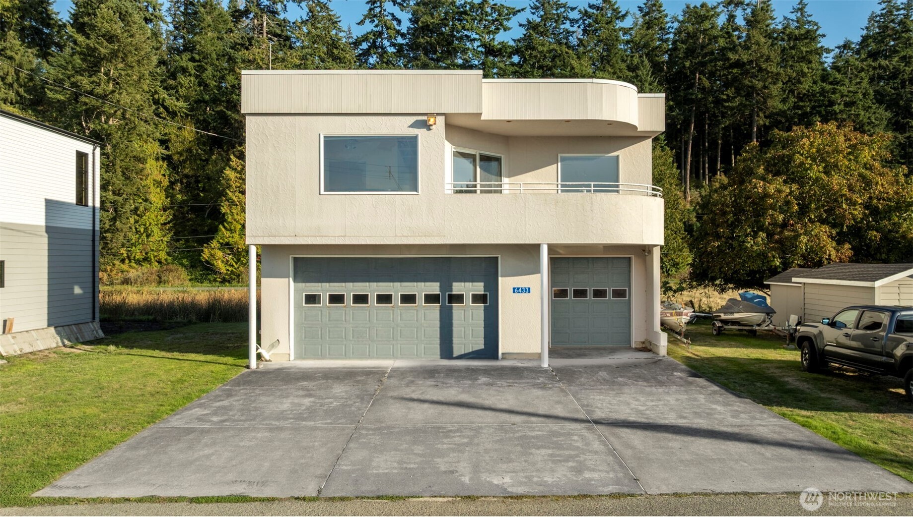 6436 South Ebb Tide Lane Freeland, WA 98249 - Photo 33 of 40 a view of a white house with a outdoor space