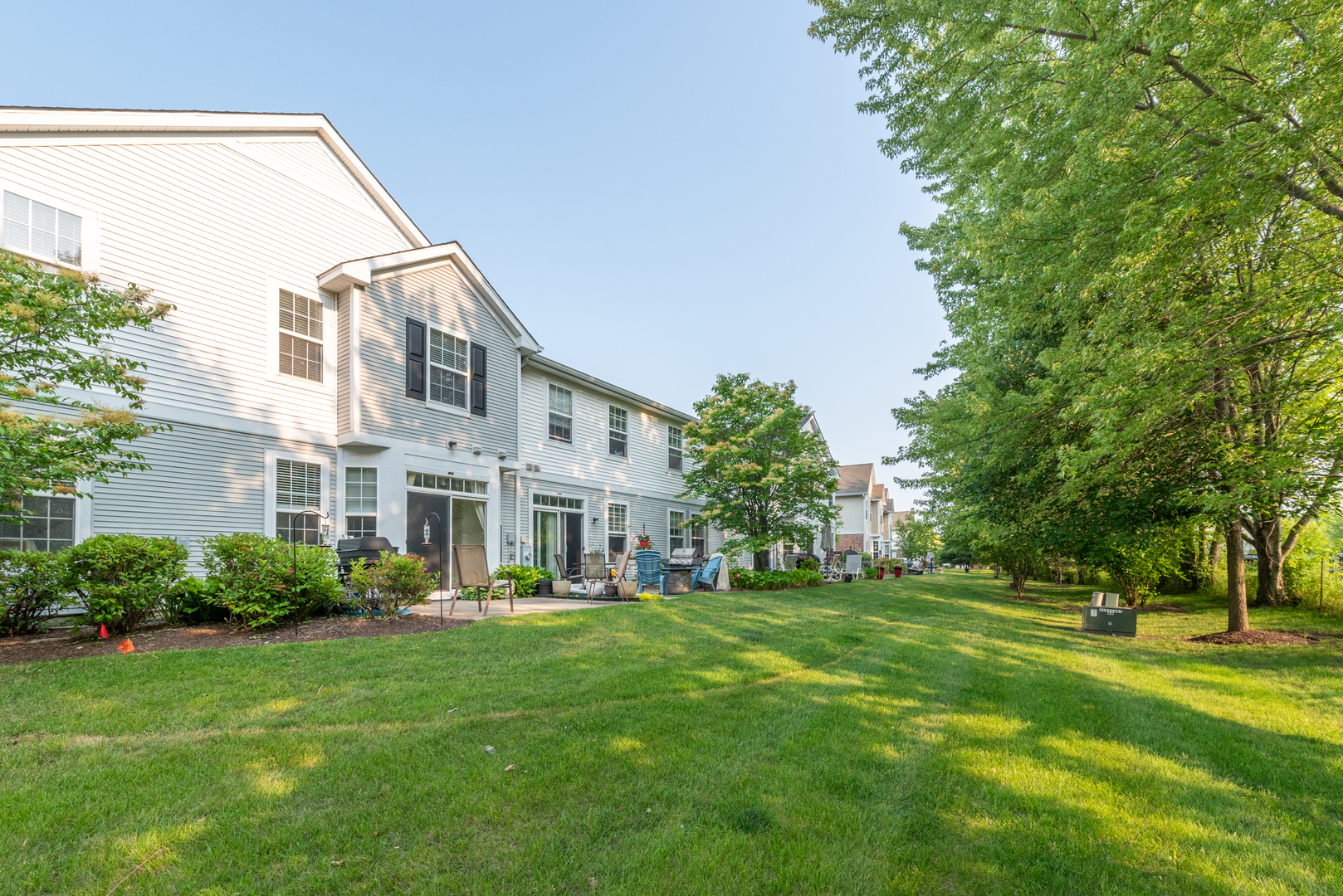 1430 Millbrook Drive Algonquin, IL 60102 - Photo 21 of 25 a view of a house with a big yard and large trees