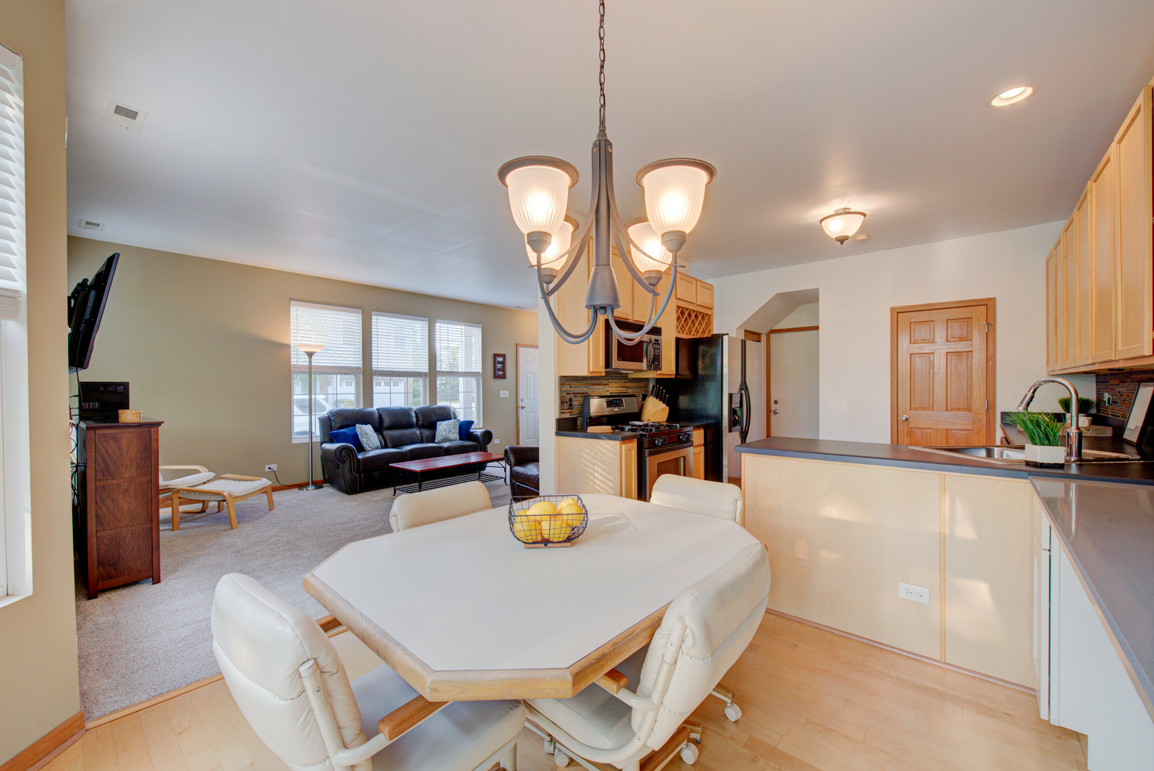 1430 Millbrook Drive Algonquin, IL 60102 - Photo 5 of 25 a dining room with wooden floor a chandelier a wooden table and chairs