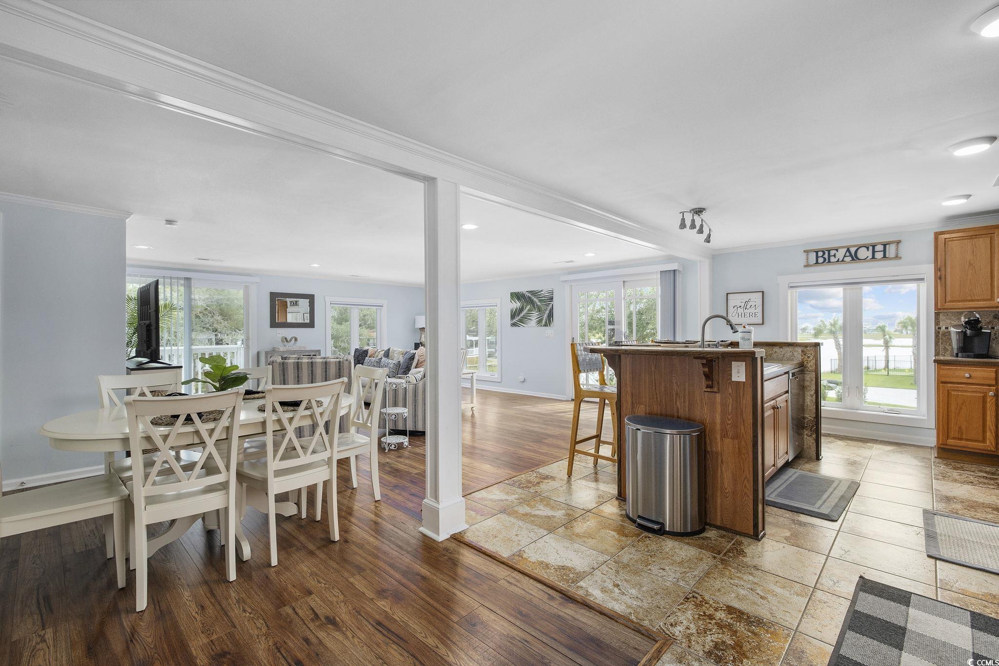 3184 State Rd S-26-816 Murrells Inlet, SC 29576 - Photo 12 of 40 Kitchen featuring ornamental molding, hardwood / wood-style flooring, a kitchen bar, and a kitchen island with sink