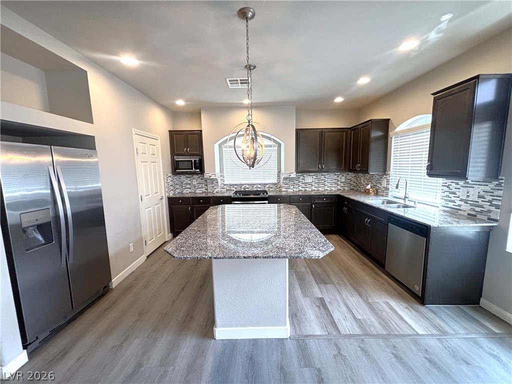 6425 Jackson Spring Road Las Vegas, NV 89118 - Photo 8 of 31 Culinary adventures await in this kitchen, featuring an island and stainless steel appliances.