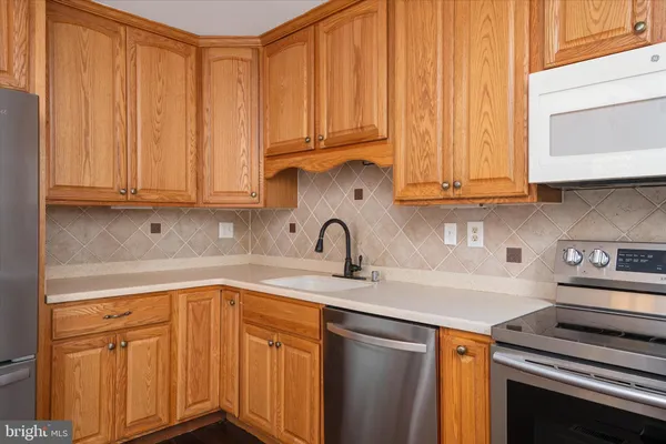 a kitchen with stainless steel appliances granite countertop a sink a stove and dishwasher with cabinets