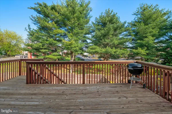 a balcony with wooden floor and fence