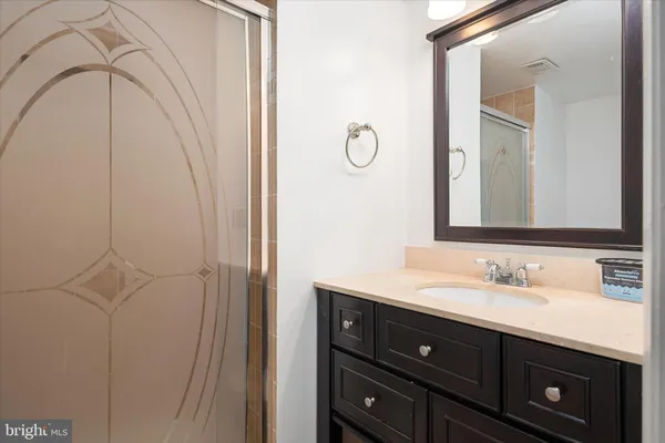 a bathroom with a sink vanity and a mirror