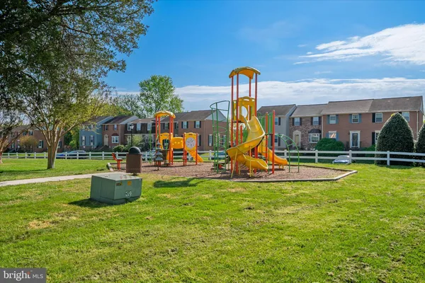 a view of a house with a swimming pool and a yard