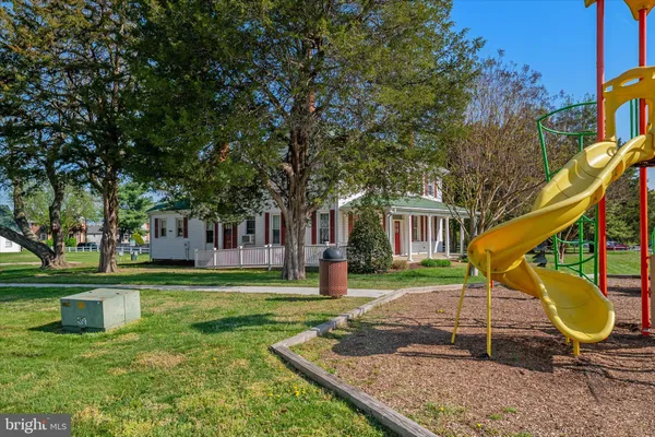 a backyard of a house with trampoline fire pit tables and chairs