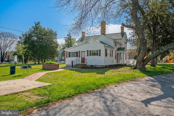 a front view of house with yard and green space