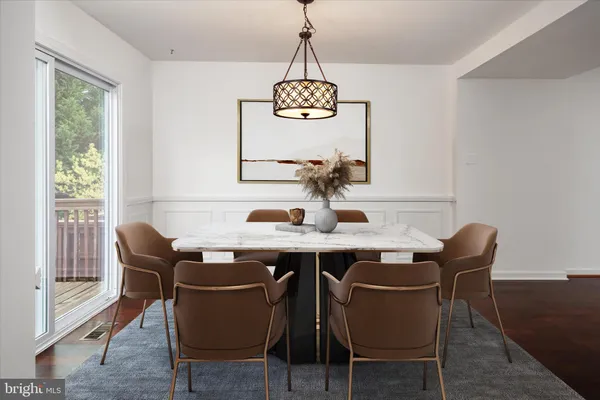 a dining room with furniture window and wooden floor