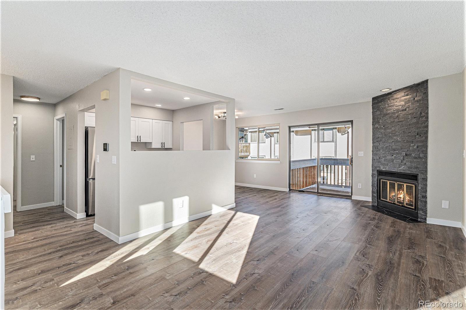 a view of livingroom with hardwood floor and a fireplace