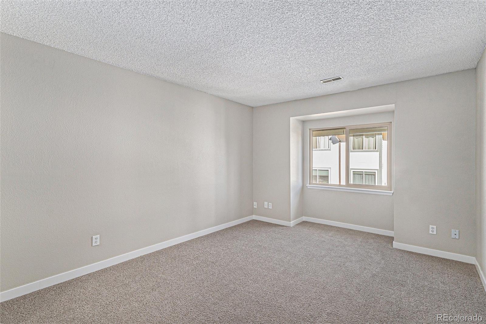 8414 South Everett Way, Unit F Littleton, CO 80128 - Photo 7 of 13 a view of an empty room with a window